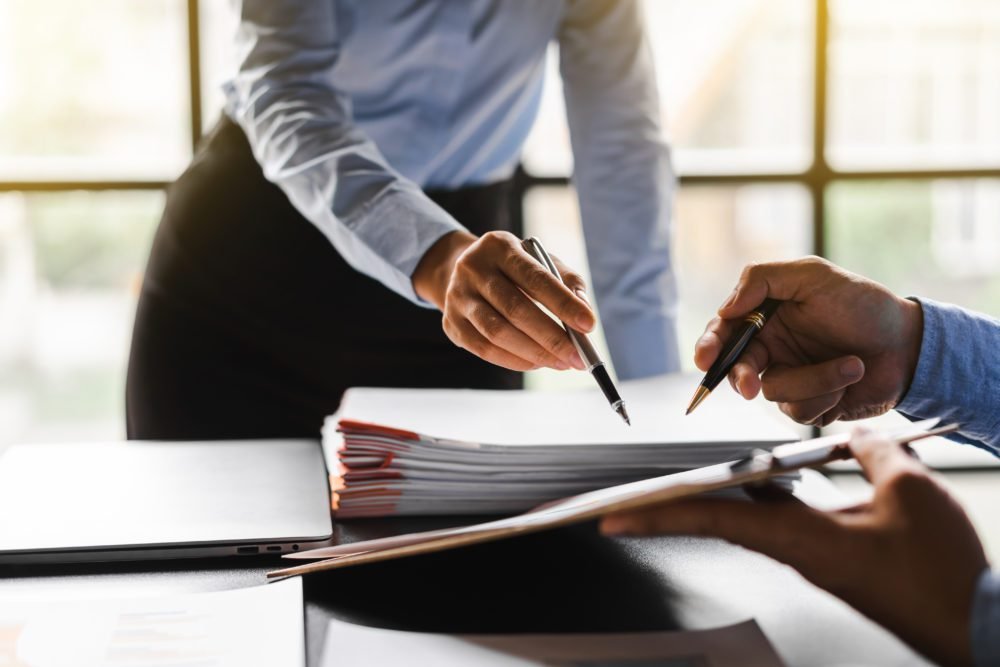Woman reviewing a large report document
