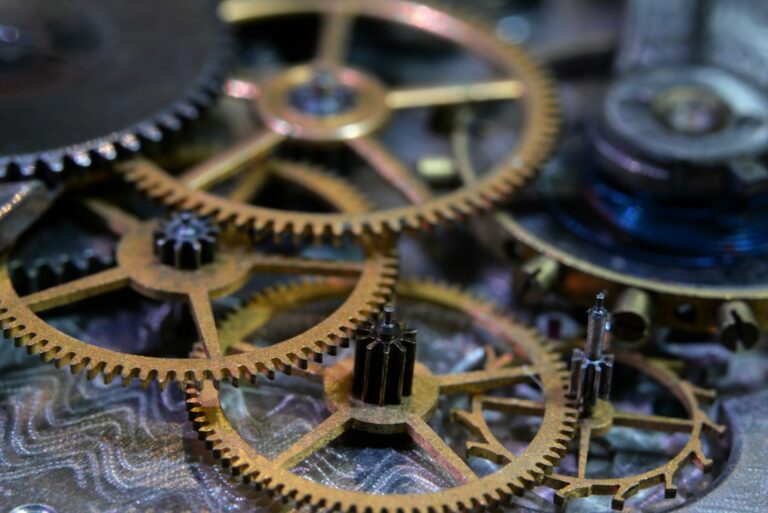 Interlocking gears of a watch movement, representing several ISO management systems working together as one integrated system
