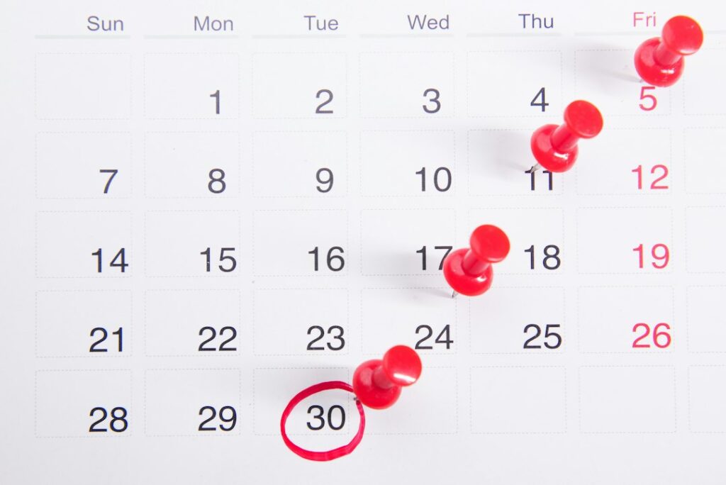 Calendar with red pins marking key dates, representing the 2026 ISO standards transition deadlines